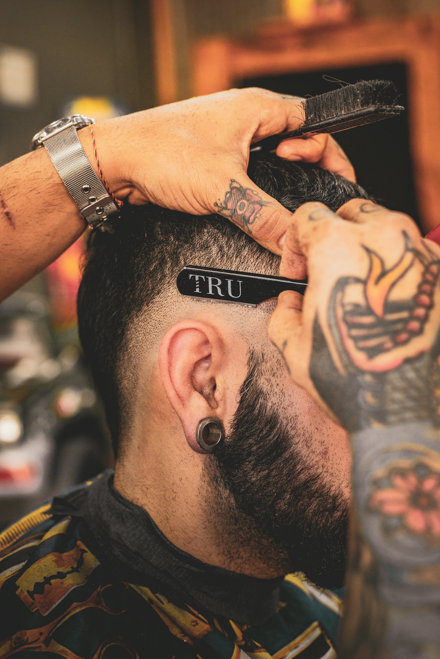 Barber blending a clean skin fade with a straight razor at Iron Edge Barbershop