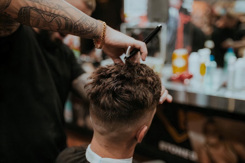 Barber giving a precision classic haircut with scissors and comb