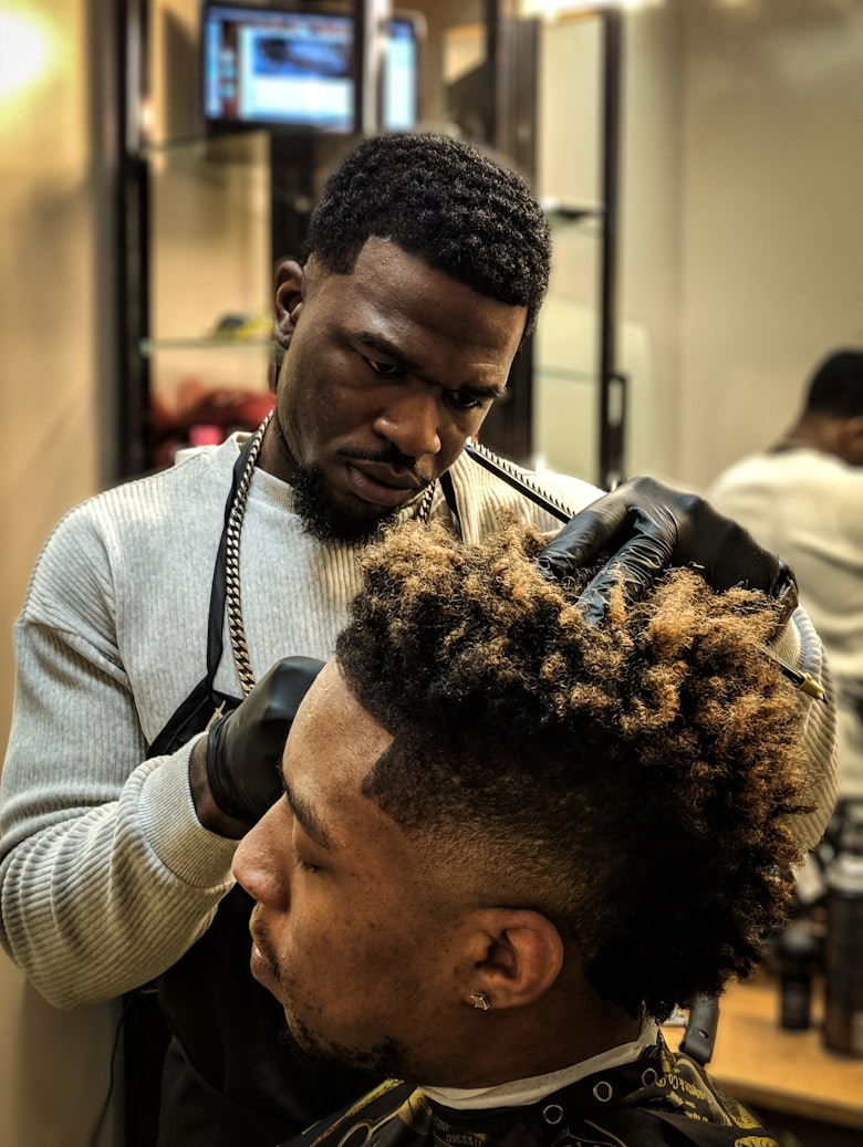 Barber blending a razor-sharp skin fade