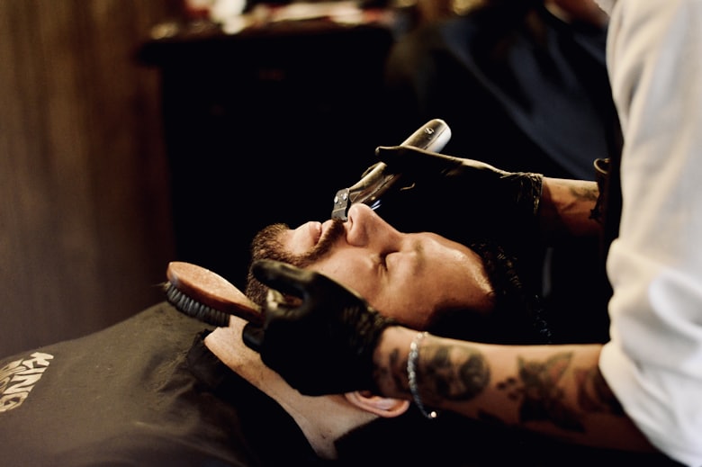 Client receiving a traditional hot towel straight razor shave